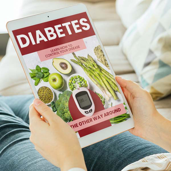 Person holding a tablet displaying an eBook titled ‘Diabetes: Learn How to Control Your Disease – The Other Way Around,’ featuring healthy foods like avocado, asparagus, peas, and a glucose meter on the cover.