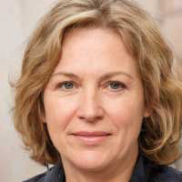 Portrait of a middle-aged woman with short blonde hair, wearing a dark top, looking at the camera with a calm and confident expression — suitable for a customer testimonial or review section.